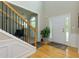 Bright foyer with hardwood floors, staircase with black iron spindles, and a view of the front door at 118 Brendylynn Trce, Woodstock, GA 30188
