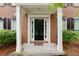 Covered front entry featuring a classic black door flanked by sidelights and brick columns at 118 Brendylynn Trce, Woodstock, GA 30188