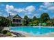 Community pool with lounge chairs and clubhouse in a well-maintained neighborhood at 118 Brendylynn Trce, Woodstock, GA 30188