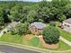 Aerial view of a brick two-story home with a landscaped yard and mature trees on a sunny day at 208 Regency Ct, Acworth, GA 30102