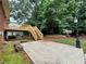 View of the deck, patio, and landscaped backyard in a mature wooded setting at 208 Regency Ct, Acworth, GA 30102