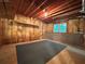 Unfinished basement with exposed wood ceiling, insulation, and a window providing natural light at 208 Regency Ct, Acworth, GA 30102