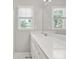 Bright bathroom with a white vanity top and natural light from the window at 208 Regency Ct, Acworth, GA 30102