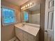 Bathroom with a window, vanity, mirror, and neutral walls at 208 Regency Ct, Acworth, GA 30102
