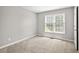Bedroom featuring a large window, neutral walls, and carpeted floors at 208 Regency Ct, Acworth, GA 30102