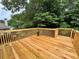 Deck view with wood boards and railing offering a view of the wooded backyard at 208 Regency Ct, Acworth, GA 30102