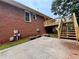Rear exterior view showing brick, deck, patio, and flower boxes with flowers at 208 Regency Ct, Acworth, GA 30102