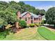 Beautiful brick home featuring lush lawn and manicured landscaping at 208 Regency Ct, Acworth, GA 30102