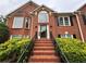 Classic brick home with stately entrance and black trimmed windows at 208 Regency Ct, Acworth, GA 30102