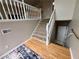 Grand foyer with hardwood flooring and carpeted steps with white railing at 208 Regency Ct, Acworth, GA 30102
