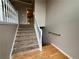 Inviting foyer with hardwood floors and carpeted staircase with white railing at 208 Regency Ct, Acworth, GA 30102