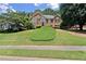 Charming brick home with a well-manicured lawn and lush landscaping creating beautiful curb appeal at 208 Regency Ct, Acworth, GA 30102