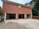 Red brick garage with three bays, offering ample parking and storage options at 208 Regency Ct, Acworth, GA 30102