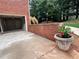 Brick garage exterior with three garage bays, landscaping, and driveway access at 208 Regency Ct, Acworth, GA 30102