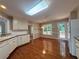 Bright kitchen with white cabinets, stainless steel appliances, and hardwood flooring at 208 Regency Ct, Acworth, GA 30102