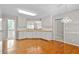 Spacious kitchen with wood floors, white cabinets, and neutral countertop at 208 Regency Ct, Acworth, GA 30102