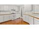 Bright kitchen with wood floors, white cabinets, and ample counter space at 208 Regency Ct, Acworth, GA 30102
