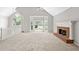 Bright living room featuring a fireplace, large windows and neutral carpet at 208 Regency Ct, Acworth, GA 30102