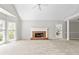 Open-concept living room with fireplace, large windows, and neutral carpet at 208 Regency Ct, Acworth, GA 30102