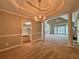 Open-concept dining and living room with elegant chandelier and fireplace at 208 Regency Ct, Acworth, GA 30102