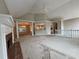 Open-concept living room with columns, fireplace, and vaulted ceiling at 208 Regency Ct, Acworth, GA 30102
