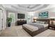 Main bedroom featuring a tray ceiling and a decorative accent wall at 208 Regency Ct, Acworth, GA 30102