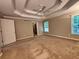 Large main bedroom with tray ceilings, a ceiling fan, and generous space at 208 Regency Ct, Acworth, GA 30102