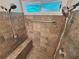 Tiled walk-in shower with dual showerheads and a built-in bench at 208 Regency Ct, Acworth, GA 30102