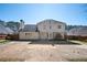 Back exterior featuring a two-story home with a large backyard, complemented by mature trees and fencing at 3090 Perch Sw Ln, Marietta, GA 30008