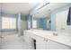 Primary bathroom with blue walls, white cabinets, a tub, a glass shower, and a double vanity at 3090 Perch Sw Ln, Marietta, GA 30008