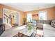 Bright and airy living room featuring neutral walls, carpeted flooring, and a comfortable sectional sofa at 3090 Perch Sw Ln, Marietta, GA 30008