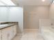 Bathroom featuring a double vanity, bathtub, and glass door shower at 5888 Old Wellborn Trce, Lithonia, GA 30058