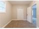 Bedroom with carpet and neutral walls, featuring closet and doorway at 5888 Old Wellborn Trce, Lithonia, GA 30058
