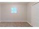 A carpeted bedroom with a window for natural light and a closet for storage at 5888 Old Wellborn Trce, Lithonia, GA 30058