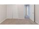 Carpeted bedroom with a closet, doorway, and neutral paint throughout at 5888 Old Wellborn Trce, Lithonia, GA 30058