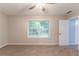 Bedroom with carpet, neutral paint, window, ceiling fan, and white door at 5888 Old Wellborn Trce, Lithonia, GA 30058