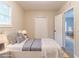 Staged bedroom showcasing a bed, closet, and doorway to another room at 5888 Old Wellborn Trce, Lithonia, GA 30058
