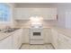 Bright kitchen with ample cabinet space and white appliances at 5888 Old Wellborn Trce, Lithonia, GA 30058