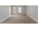 Bright living room with carpet, neutral color palette, and natural light at 5888 Old Wellborn Trce, Lithonia, GA 30058