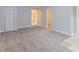 Spacious living room with carpet, neutral color palette, and multiple entry points at 5888 Old Wellborn Trce, Lithonia, GA 30058