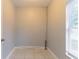 A room with tile floors and a window with white blinds providing natural light at 5888 Old Wellborn Trce, Lithonia, GA 30058