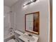 Bathroom with white tile tub, vanity, and wood trimmed mirror at 617 Rock Springs Rd, Lawrenceville, GA 30043