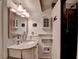 Well-lit bathroom with a sleek vanity, granite countertop, and updated fixtures with a dark tiled shower at 617 Rock Springs Rd, Lawrenceville, GA 30043
