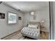 Cozy bedroom with modern decor, a tufted chaise lounge, and natural light from the window at 617 Rock Springs Rd, Lawrenceville, GA 30043