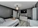 Stylish bedroom features gray walls, wood floors, a brick accent wall, and modern furnishings at 617 Rock Springs Rd, Lawrenceville, GA 30043