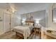 Cozy bedroom with wood floors, wood-planked walls, and stylish beach-themed art at 617 Rock Springs Rd, Lawrenceville, GA 30043