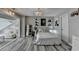 Bright bedroom area with a queen bed, sitting area, and stylish decor at 617 Rock Springs Rd, Lawrenceville, GA 30043