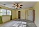 Bright bedroom with ceiling fan, window and closet at 617 Rock Springs Rd, Lawrenceville, GA 30043