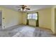 Bedroom with ceiling fan, large window with curtains, and light colored walls at 617 Rock Springs Rd, Lawrenceville, GA 30043