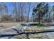 Scenic driveway leading to a house surrounded by mature trees and landscaping at 617 Rock Springs Rd, Lawrenceville, GA 30043